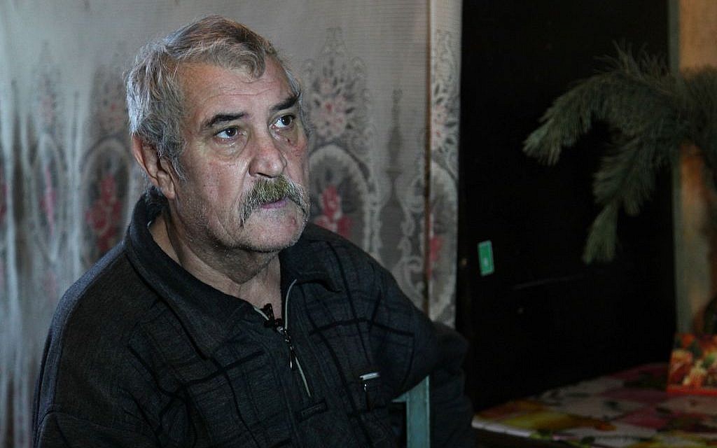 In Artemovsk, homebound pensioner Leonid Annov, 67, lives with his wife and grandson in an uninsulated apartment in eastern Ukraine. (courtesy JDC)