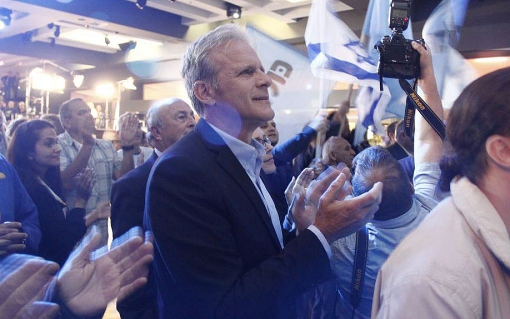 Michael Oren, number four on the Kulanu party's list, applauds as exit polls show his party is slated to receive between nine and ten seats in the 20th Knesset on March 17, 2015. It wound up with 10. (Photo credit: Judah Ari Gross/Times of Israel)