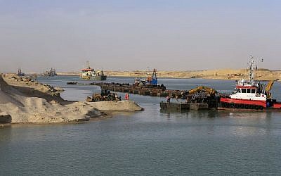 Dredgers work on a new section of the Suez canal Feb. 4, 2015, during a media tour in Ismailia, Egypt. The Suez Canal Authority is in a race to quickly expand the vital waterway for two-way traffic by August 2015. (Photo credit: AP/Hassan Ammar, File)