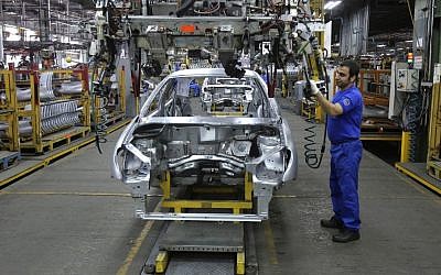 An Iranian worker assembles a car at the Iran Khodro automobile manufacturing plant, just outside Tehran, Iran,  January 18, 2014. (photo credit: AP/Vahid Salemi, File)