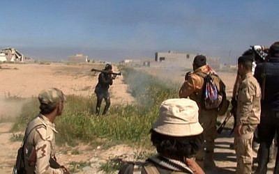 In this still image taken from video a soldier fires a rocket propelled grenade (RPG) in Tikrit, Iraq on Wednesday, March 11, 2015. (Photo credit: AP)