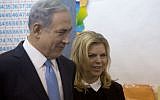Prime Minister Benjamin Netanyahu stands with his wife Sara after voting in Israel's parliamentary elections in Jerusalem, Tuesday, Mar. 17, 2015. (photo credit: AP Photo/Sebastian Scheiner, Pool)