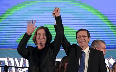 Zionist Union party co-leaders Isaac Herzog and Tzipi Livni greet supporters at the party's election headquarters in Tel Aviv, Israel, Wednesday, March 18, 2015. (Photo credit: AP/Ariel Schalit)