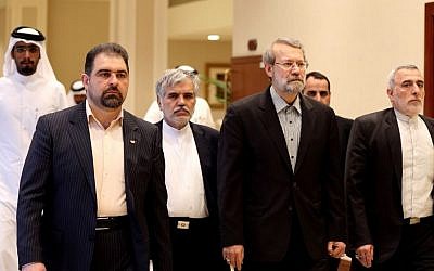 Iranian Parliament Speaker Ali Larijani, center, arrives to address a press conference in Doha, Qatar,Wednesday, March 11, 2015.  (Photo credit: AP/Osama Faisal)