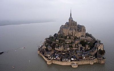 An aerial view as a high tide submerges a narrow causeway leading to the Mont Saint-Michel, on France's northern coast, Saturday, March 21, 2015. (photo credit: AP Photo)