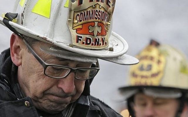 New York's Fire Commissioner Daniel Nigro describes the fire to reporters during a news conference, Saturday, March 21, 2015, in the Brooklyn borough of New York, Saturday, March 21, 2015. The fire raged through a residence early Saturday, killing seven children and leaving two other people in critical condition, authorities said. (photo credit: AP Photo/Mary Altaffer)
