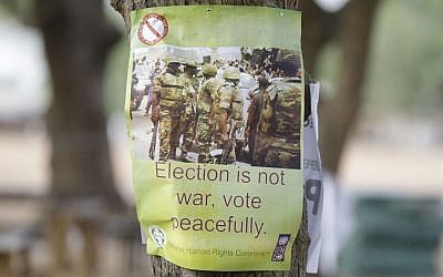 A poster warning people to vote peacefully is seen in one of the polling stations in Yola, Nigeria Saturday, March 28, 2015. (photo credit: AP/Sunday Alamba) 