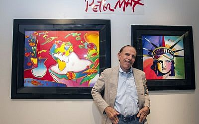 Artist Peter Max poses for a photo during his retrospective with the Road Show Company exhibit in Northbrook Court mall in Northbrook, Ill. Since he charged onto the pop-art stage a half-century ago, the progenitor of psychedelic art has stamped his creative presence on practically everything from the sides of an airliner and the hull of a Norwegian Cruise Lines ship to commemorative US postage stamps and, most lately, an endless string of art galleries stretching from one end of the United States to the other. (photo credit: Barry Brecheisen/Invision/AP)