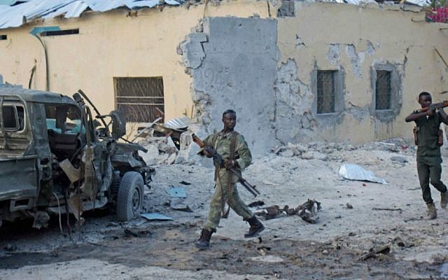 Somali soldiers take position after a bomb that was detonated at the gate of one of Mogadishu's most popular hotel on Friday, March, 27, 2015. (photo credit: AP/Farah Abdi Warsameh) Somali soldiers take position after a bomb that was detonated at the gate of one of Mogadishu's most popular hotel on Friday, March, 27, 2015. (photo credit: AP/Farah Abdi Warsameh)