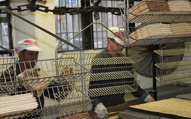 At the Streit's factory on the Lower East Side of Manhattan, matzah is broken into pieces and sent to be packaged in the same way it has been for over half a century. (Gabe Friedman/JTA) At the Streit's factory on the Lower East Side of Manhattan, matzah is broken into pieces and sent to be packaged in the same way it has been for over half a century. (Gabe Friedman/JTA)
