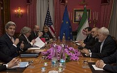 US Secretary of State John Kerry (left), during a meeting with Iran's Foreign Minister Mohammad Javad Zarif (seated opposite), over Iran's nuclear program, in Lausanne, Switzerland, on March 19, 2015. (photo credit: AP/Brian Snyder, Pool)