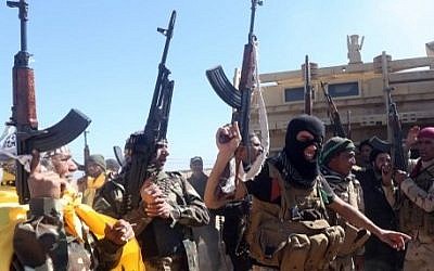 Iraqi pro-government fighters celebrate as they advance into Tikrit, 160 kms north of Baghdad, during a military operation to regain the city from jihadists from the Islamic state (IS) group, on March 11, 2015. (photo credit: AFP PHOTO / AHMAD AL-RUBAYE)