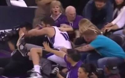 Omri Casspi crashes into a young spectator, March 22, 2015 (YouTube screenshot)