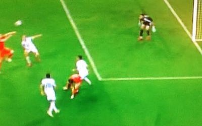 Aaron Ramsey (left, in red) heads Wales into a 1-0 lead over Israel in their March 28, 2015 European Championship qualifier (Channel 1 screenshot)