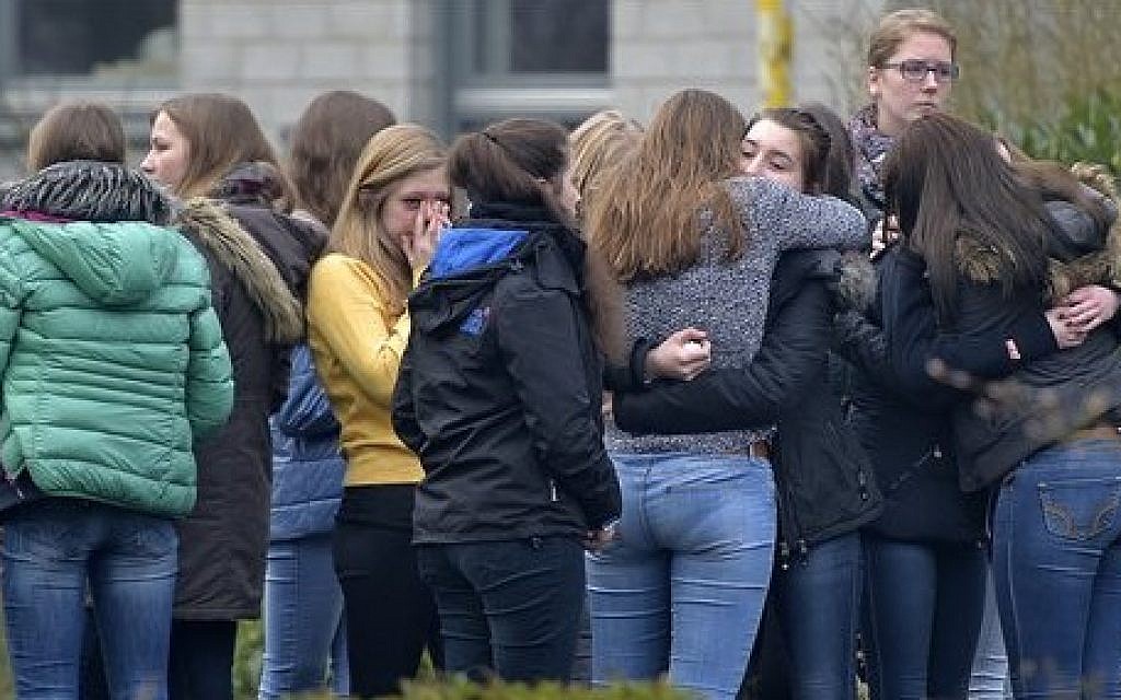 Students mourn in front of the Joseph-Koenig Gymnasium in Haltern, western Germany, Wednesday, March 25, 2015, one day after 16 school children and two teachers were among the 150 victims that died in the Germanwings plane crash in the French alps on the way from Barcelona to Duesseldorf. (photo credit: AP Photo/Martin Meissner)