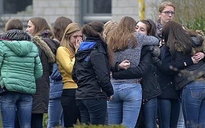Students mourn in front of the Joseph-Koenig Gymnasium in Haltern, western Germany, Wednesday, March 25, 2015, one day after 16 school children and two teachers were among the 150 victims that died in the Germanwings plane crash in the French alps on the way from Barcelona to Duesseldorf. (photo credit: AP Photo/Martin Meissner)