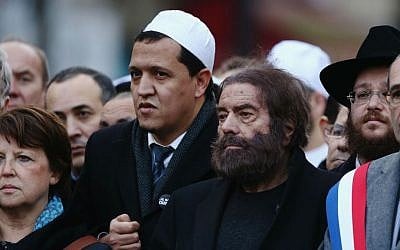 Marek Halter, second from right, and Hassen Chalghoumi, in white cap, at a mass rally in Paris following the shootings at the Charlie Hebdo magazine and the Hyper Cacher supermarket, Jan. 11, 2015. (Dan Kitwood/Getty Images/JTA)