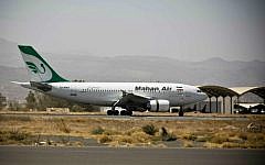 A plane from the Iranian private airline Mahan Air lands the international airport in Sanaa, Yemen, Sunday, March 1, 2015 (AP Photo/Hani Mohammed)