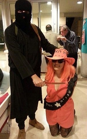 A couple working at the Israeli Foreign Ministry dress up as IS's 'Jihadi John' and a female hostage, respectively for Purim, March 3, 2015. (Photo credit: Courtesy)