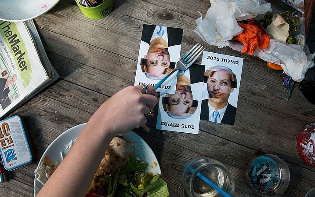 Postcards made by an Israeli artist reading "Nausea" with faces of leaders of the different Israeli party leaders distributed in Tel Aviv, ahead of the elections which will be held on March 17. The word "nausea" in Hebrew rhymes with "elections." (photo credit: Danielle Shitrit/FLASH90)