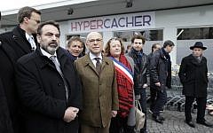 French Interior Minister Bernard Cazeneuve (2L) and French Jewish central Consistory President Joel Mergui (L) arrive on March 15, 2015 at the Hyper Cacher Jewish supermarket in Paris that became the site of a bloody hostage drama during a jihadist attack in January (photo credit: AFP/ KENZO TRIBOUILLARD)