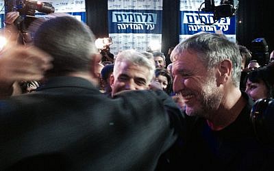 Yesh Atid party leader Yair Lapid, hugging each supporter at the end of election night (photo credit: Jessica Steinberg/Times of Israel)