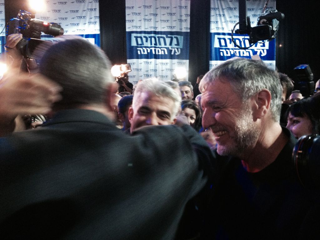 Yesh Atid party leader Yair Lapid, hugging each supporter at the end of election night (photo credit: Jessica Steinberg/Times of Israel)