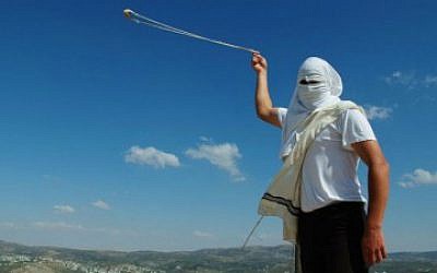 A Jewish settler hurling rocks, illustrative photo (Mendy Hechtman/Flash90)