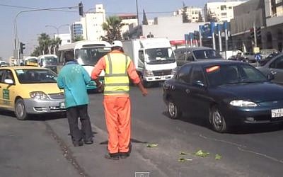 A Jordanian sanitation worker (screen capture: YouTube)