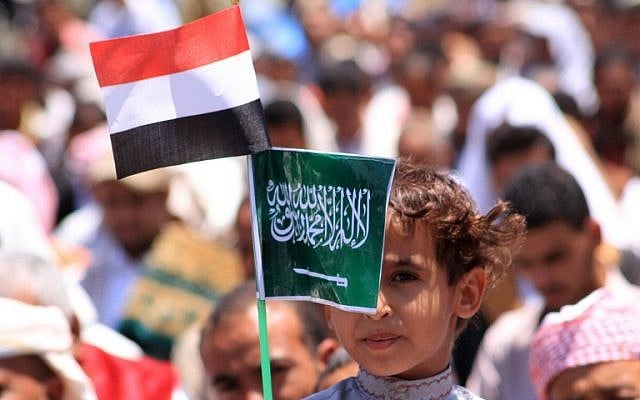 A Yemeni child holds Saudi (R) and Yemeni national flags during a demonstration in the strategic city of Taez on March 27, 2015, in support of the Saudi-led operation against Shiite rebels in the country (photo credit: AFP/STR) A Yemeni child holds Saudi (R) and Yemeni national flags during a demonstration in the strategic city of Taez on March 27, 2015, in support of the Saudi-led operation against Shiite rebels in the country (photo credit: AFP/STR)