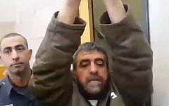 Sidqi al-Maqt, arrested for spying for Syria, raises his arms as he speaks to reporters, March 27, 2015 (Screen capture: Channel 2)