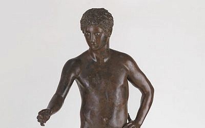 Roman statue of a young god or athlete, provenance unknown, 1st century BCE–1st century CE, bronze, glass from the Belfer Collection (photo credit: © The Israel Museum, Jerusalem, Elie Posner)
