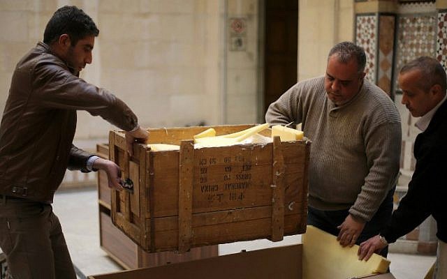 Damascus Museum employees wrap archaeological artifacts into boxes to protect them from being damaged on March 24, 2015, in the Syrian capital (photo credit: AFP PHOTO / JOSEPH EID) Damascus Museum employees wrap archaeological artifacts into boxes to protect them from being damaged on March 24, 2015, in the Syrian capital (photo credit: AFP PHOTO / JOSEPH EID)