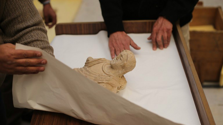 Damascus Museum employees wrap archaeological artifacts into boxes to protect them from being damaged on March 24, 2015, in the Syrian capital. Workers at Syria's National Museum of Damascus carefully wrap statues and place them in boxes to be transported to a safe place, hoping to save the priceless pieces from theft or destruction (photo credit: AFP PHOTO / JOSEPH EID) Damascus Museum employees wrap archaeological artifacts into boxes to protect them from being damaged on March 24, 2015, in the Syrian capital. Workers at Syria's National Museum of Damascus carefully wrap statues and place them in boxes to be transported to a safe place, hoping to save the priceless pieces from theft or destruction (photo credit: AFP PHOTO / JOSEPH EID)