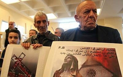 Assyrian Christians, who fled the unrest in Syria and Iraq, attend a prayer for the 220 Assyrian Christians abducted by Islamic State jihadists from villages in northeastern Syria in recent days, at the Saint Georges Assyrian Church in Jdeideh, northeast of the Lebanese capital Beirut, on February 26, 2015. (photo credit: AFP/Anwar Amro)