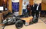 Stef Wertheimer (second right) and Dr. Amir Ziv-Av (far right) stand with Ben Gurion University engineering students at ICME 2015. The students presented a Formula One racecar they designed, March 3 2015 (Photo credit: Courtesy)