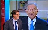 Prime Minister Benjamin Netanyahu speaks to Channel 2 as Zionist Union head Isaac Herzog sits in the studio, March 14, 2015 (Channel 2 News)