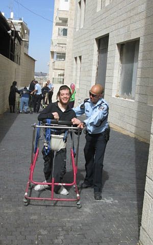 Police officers and ALEH residents train for the Jerusalem Marathon on a path outside the ALEH facility in Romema, Jerusalem. (Courtesy of ALEH Jerusalem)