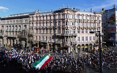 Participants hold a Hungarian flag during the "March of the Living" in the center of Budapest on April 12, 2015. (Photo credit: AFP/ ATTILA KISBENEDEK)