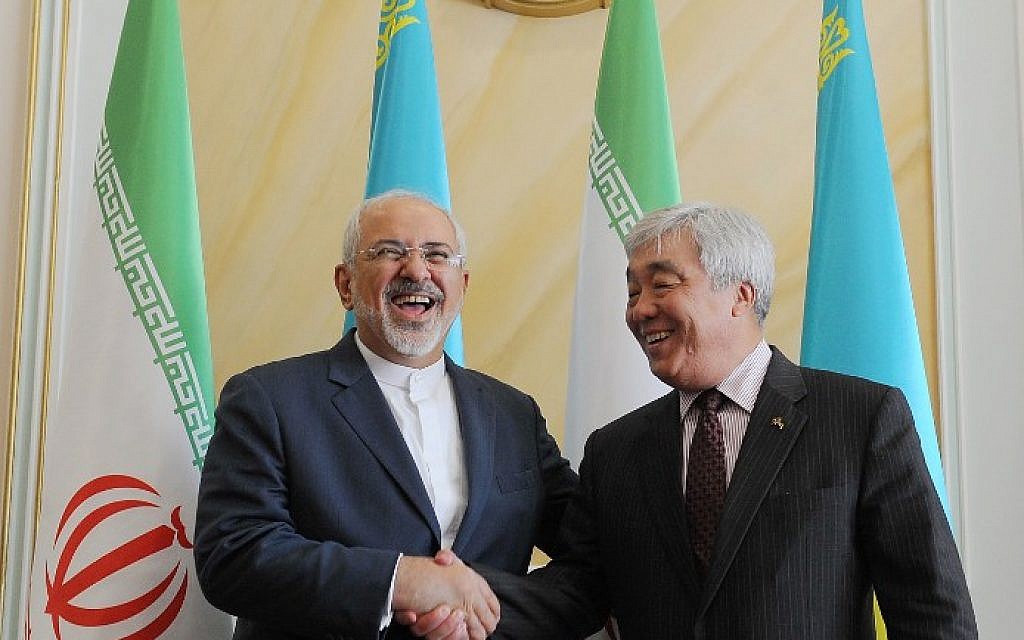 Kazakh Foreign Minister Yerlan Idrisov, right, shakes hands with his Iranian counterpart Mohammad Javad Zarif during their meeting in Astana on April 13, 2015. (photo credit: AFP/ILYAS OMAROV)