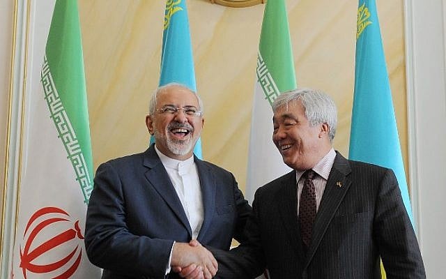 Kazakh Foreign Minister Yerlan Idrisov, right, shakes hands with his Iranian counterpart Mohammad Javad Zarif during their meeting in Astana on April 13, 2015. (photo credit: AFP/ILYAS OMAROV)
