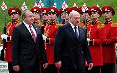 Belarus President Alexander Lukashenko, right, and his Georgian counterpart Giorgi Margvelashvili review an honor guard during a welcoming ceremony in Tbilisi on April 23, 2015. (photo credit: AFP/VANO SHLAMOV)