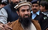 Pakistani security personnel escort Zaki-ur-Rehman Lakhvi, alleged mastermind of the 2008 Mumbai attacks, as he leaves the court after a hearing in Islamabad on January 1, 2015. photo credit: AFP/Aamir QURESHI)