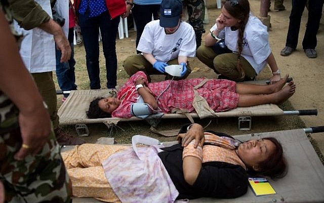 Injured Nepalese women are treated by Israeli Army medic soldiers at the Israeli field hospital on the second day of their mission in Kathmandu on April 29, 2015. (Photo credit: AFP/ MENAHEM KAHANA) Injured Nepalese women are treated by Israeli Army medic soldiers at the Israeli field hospital on the second day of their mission in Kathmandu on April 29, 2015. (Photo credit: AFP/ MENAHEM KAHANA)