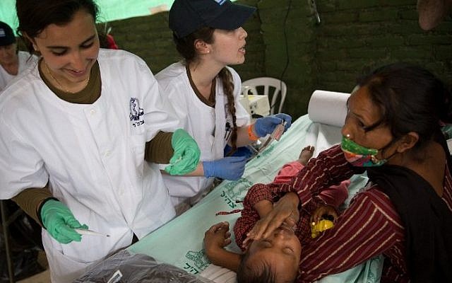 A nepalese baby is treated by Israeli Army medic soldiers at the Israeli field hospital on the second day of their mission in Kathmandu on April 29, 2015. (AFP/ MENAHEM KAHANA)