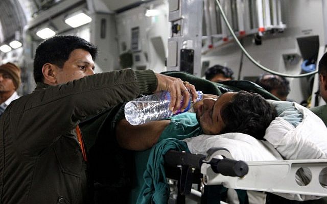 In this handout photograph taken and released by The Indian Air Force (IAF) on April 29, 2015, an injured Indian man receives water on the flight from Kathmandu to New Delhi, after he was evacuated with others from Nepal after a 7.8 magnitude earthquake struck the Himalayan nation on April 25. (photo credit: AFP PHOTO/INDIAN AIR FORCE) In this handout photograph taken and released by The Indian Air Force (IAF) on April 29, 2015, an injured Indian man receives water on the flight from Kathmandu to New Delhi, after he was evacuated with others from Nepal after a 7.8 magnitude earthquake struck the Himalayan nation on April 25. (photo credit: AFP PHOTO/INDIAN AIR FORCE)