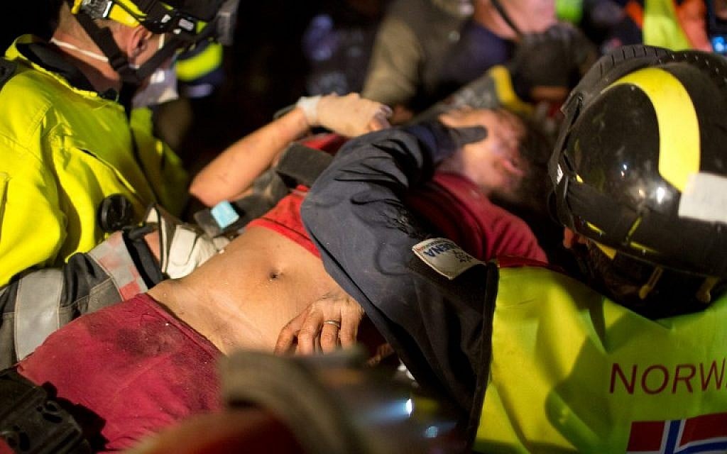 Rescue workers carry Krishna Khadka, who was pulled out alive from a collapsed building by a rescue force including Nepalese soldiers and a team of experts from France, Norway and Israel on April 30 2015 (AFP PHOTO / MENAHEM KAHANA)