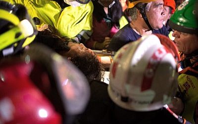 An Israeli-led rescue team carries Krishna Khadka, who was pulled out alive from a collapsed building on Thursday, April 30 2015, five days after a massive earthquake (AFP PHOTO / MENAHEM KAHANA)