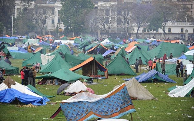 Nepalese people gather near temporary shelters set up in open areas of an Army ground in Kathmandu on April 27, 2015 (Photo credit: Prakash Mathema/AFP) Nepalese people gather near temporary shelters set up in open areas of an Army ground in Kathmandu on April 27, 2015 (Photo credit: Prakash Mathema/AFP)