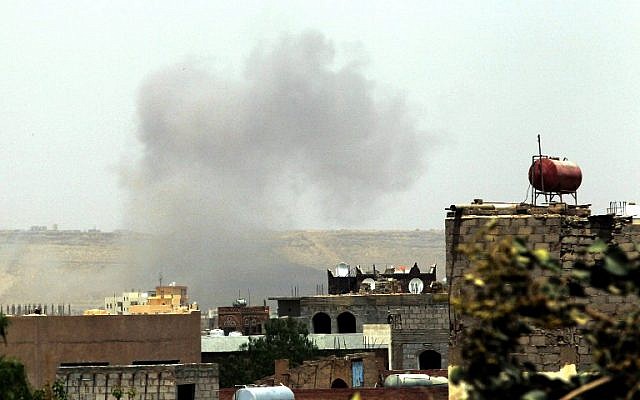 Smoke rises above the military academy in the Yemeni capital Sanaa on April 11, 2015, following an alleged air strike by the Saudi-led alliance on Shiite Houthi rebels camps. (photo credit: AFP/MOHAMMED HUWAIS) Smoke rises above the military academy in the Yemeni capital Sanaa on April 11, 2015, following an alleged air strike by the Saudi-led alliance on Shiite Houthi rebels camps. (photo credit: AFP/MOHAMMED HUWAIS)